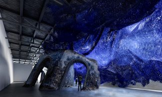 A rendering of sculpture that appears to be a sinking ruin and blue waves in the ICA's seasonal exhibition space, the Watershed