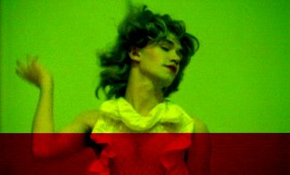 A manipulated video still showing a fair-skinned person in a white dress and red lipstick in motion.