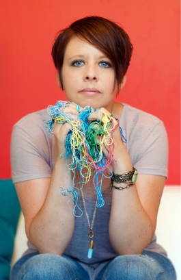 Artist holding colorful yarn