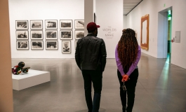 Backview of two visitors in a gallery