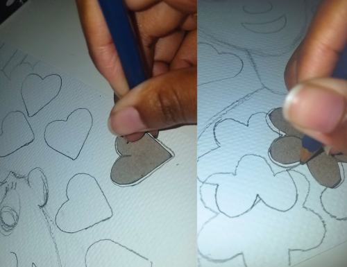 A hand tracing hearts and flower shapes overlapping other shapes on a piece of paper.