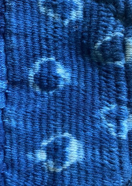 Dark blue thick knitted fabric with dyed circles
