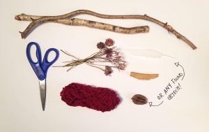 Materials on a white surface: scissors, yarn, dried flowers, sticks, feathers, nut. Text reads "or any other found materials."