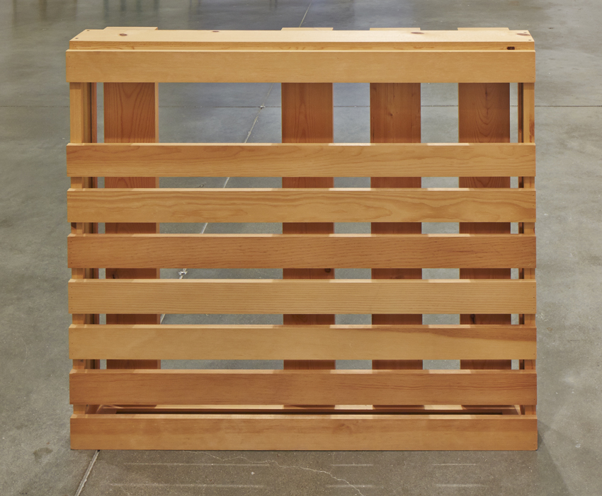 A rectilinear wooden sculpture composed of horizontal and vertical planks.