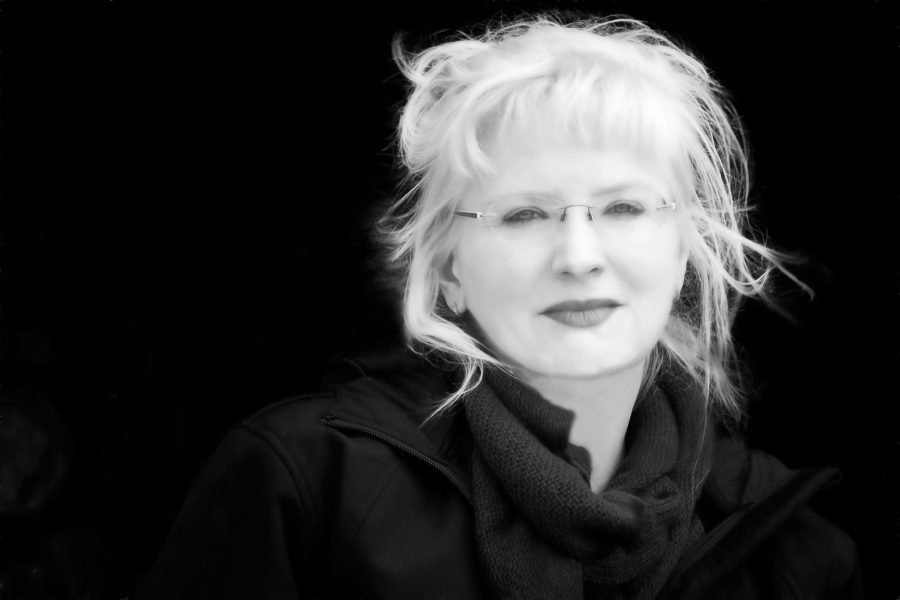 Black and white photo of woman with light hair and glasses