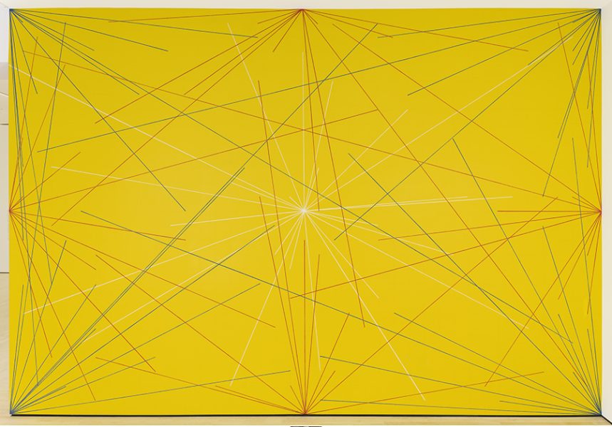 A yellow wall with white, blue, and red lines radiating from the center, corners, and sides.