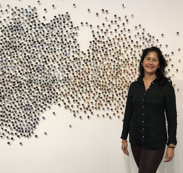 Portrait of Bennie Flores Ansell in front of her work 