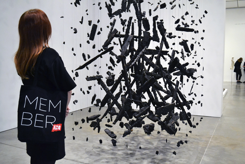 person with Membership bag in front of Cornelia Parker work