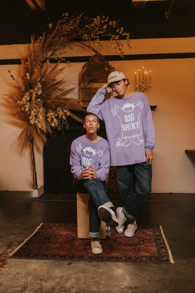 Portrait of two brothers wearing matching purple shirt