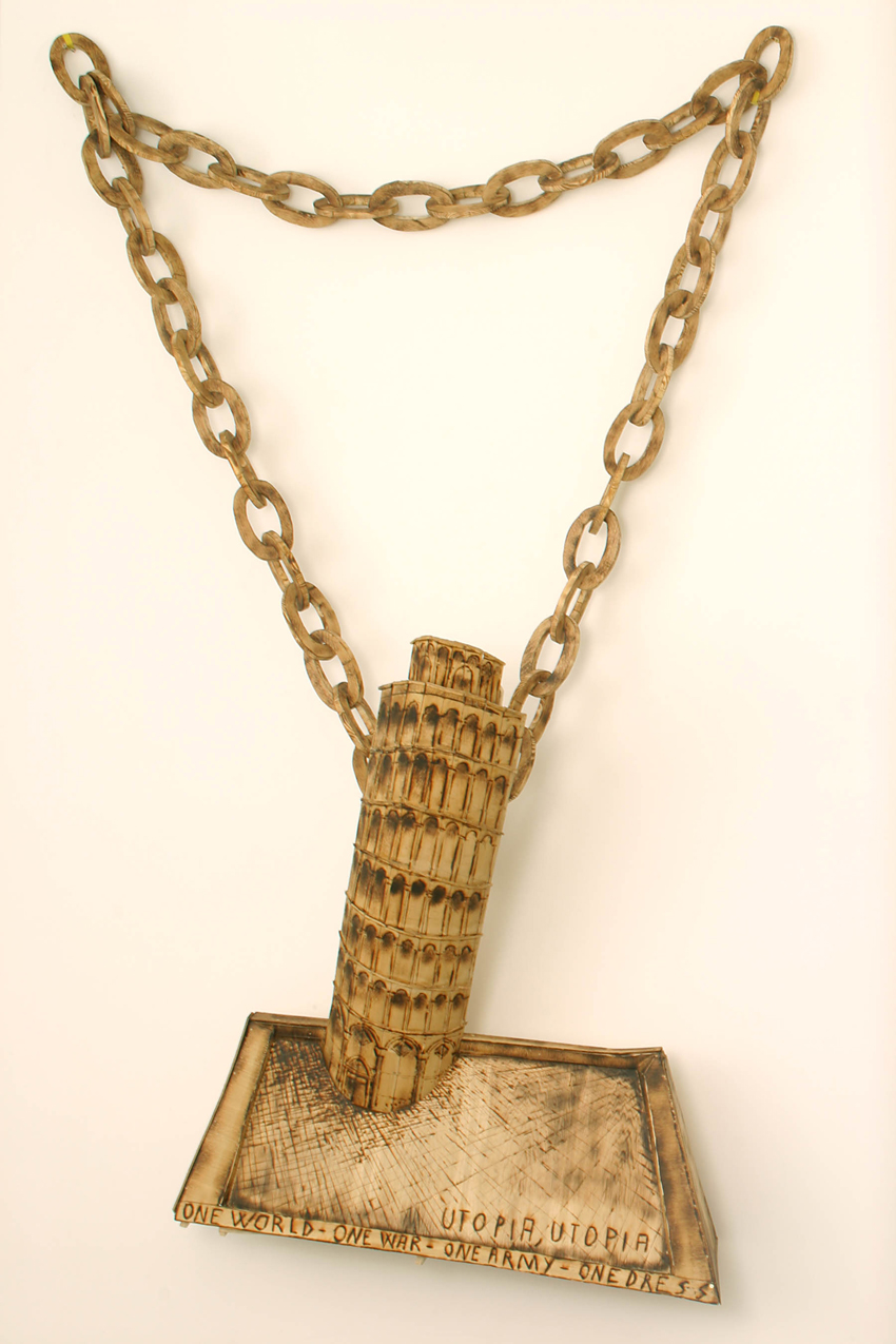 A sculpture made of carved wood and painted to appear like a miniature Tower of Pisa souvenir dangling from a chain necklace.