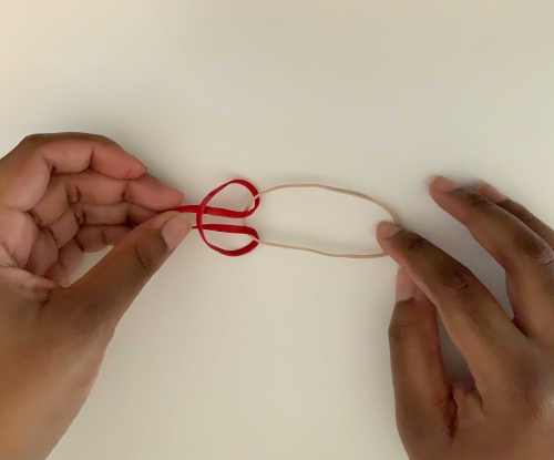 Creating a loop with a rubber band entwined with another rubber band