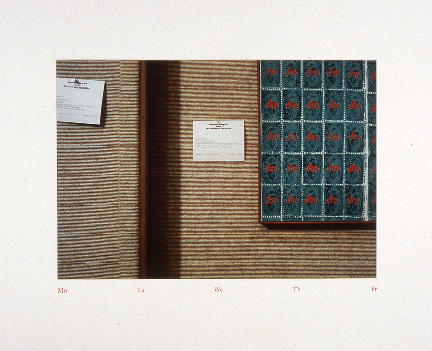 A color photograph depicts two labels tacked to the wall alongside a sheet of Andy Warhol's 
