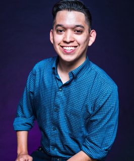 A headshot of Carlos Moreno in front of a purple background