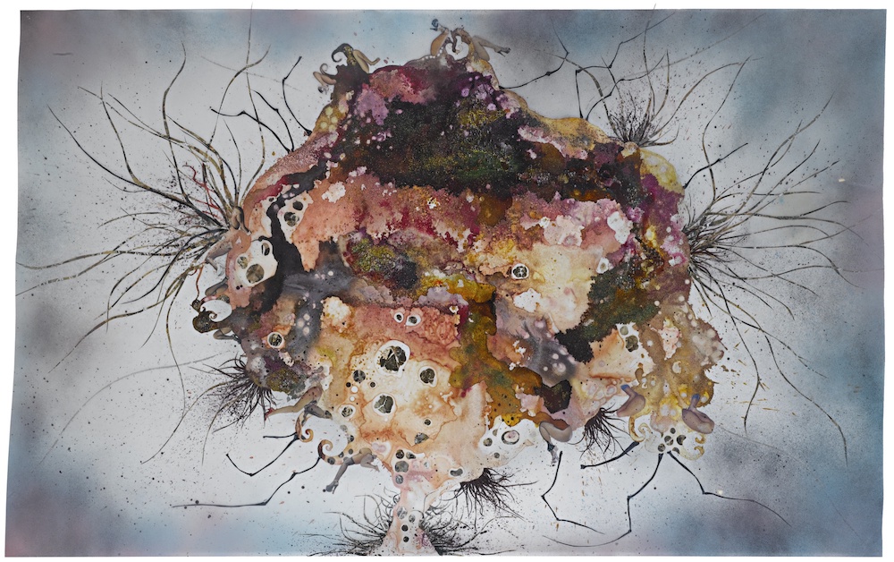 A collage of ink, acrylic, and mixed media on paper shows an organic mass or lump of various earth tones and textures with protruding antennae or hair-like growths.