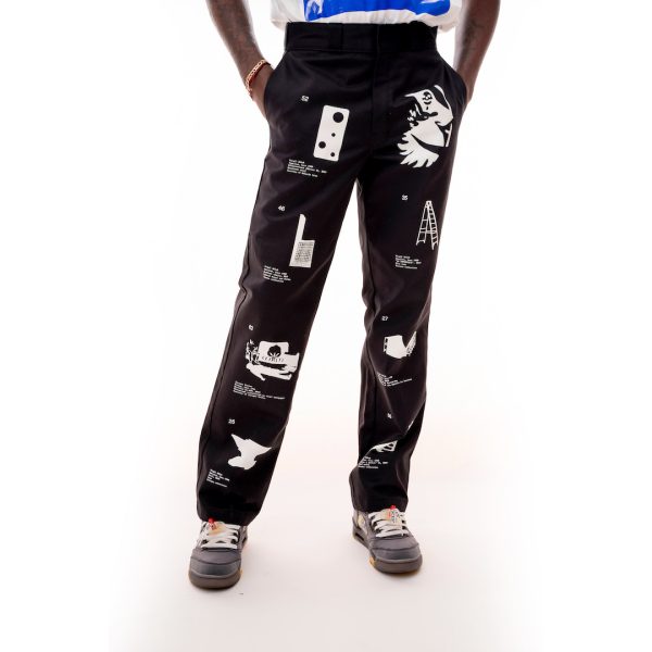 Loose black pants with four white images of artworks printed down the length of each leg, worn by a dark skinned model. 
