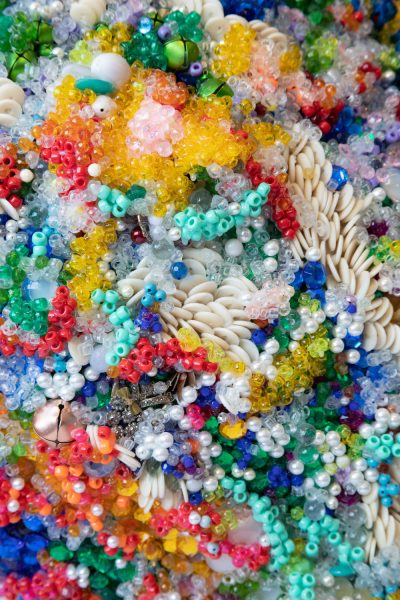A closeup of densely clustered, colorful beadwork.