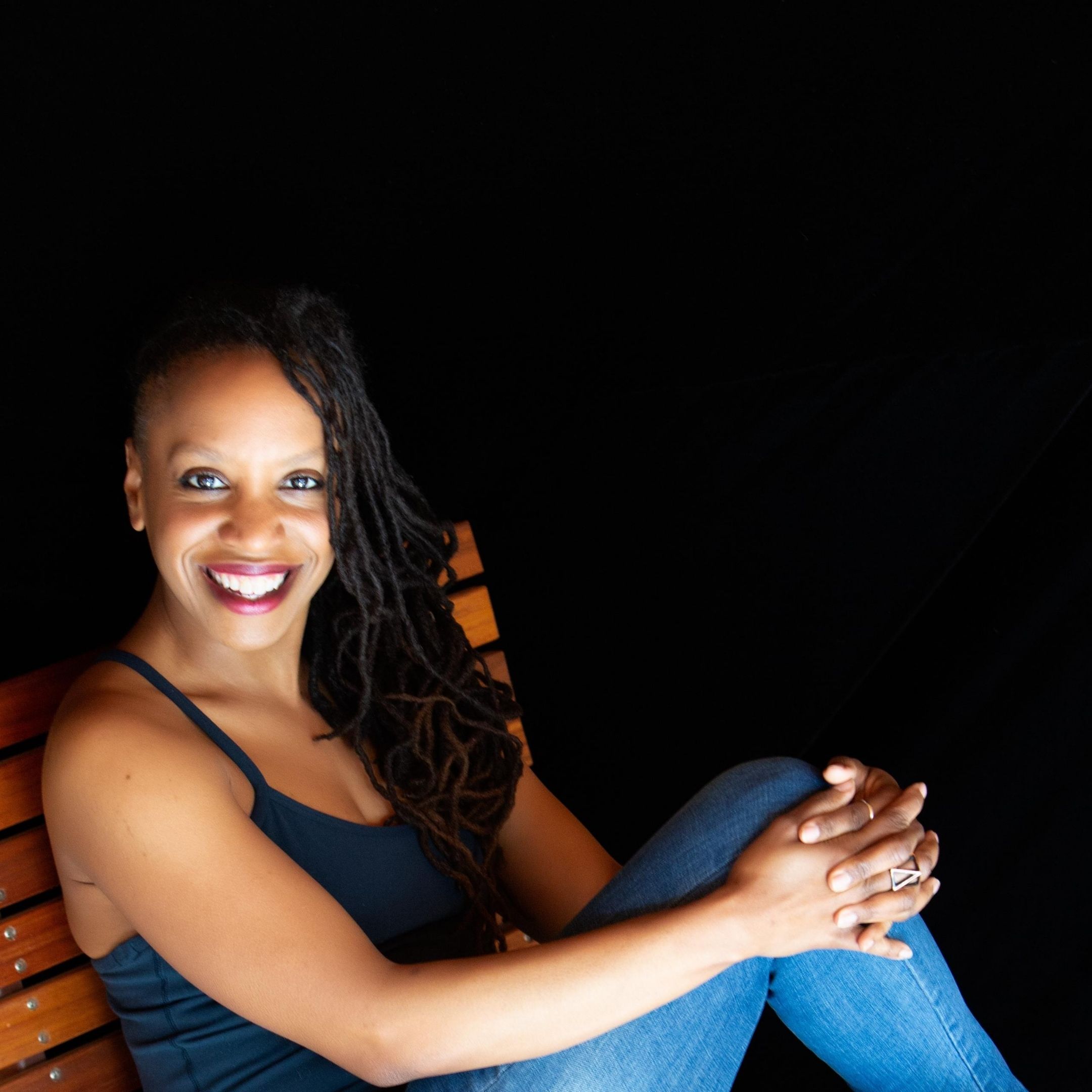 Seated headshot of Cultural Fabric founder Melissa Alexis