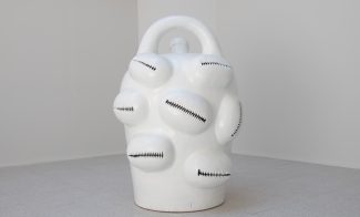 a white jug-shaped sculpture in white