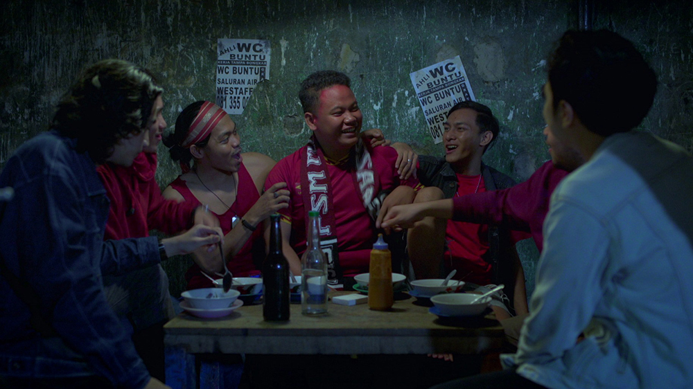 A group of people gathered around a meal, laughing