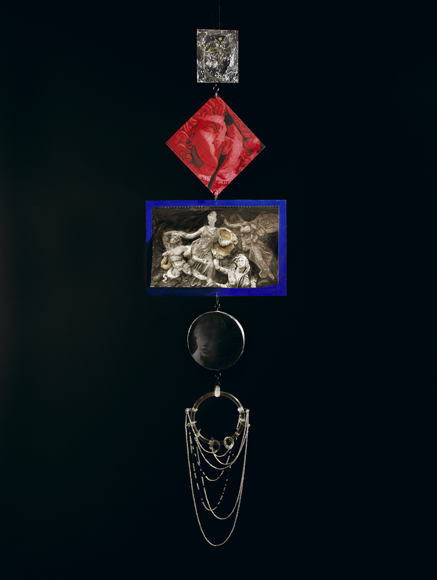 A color photograph of five objects, including other smaller images, a mirror, and a silver necklace, hung in a straight line against a black background.