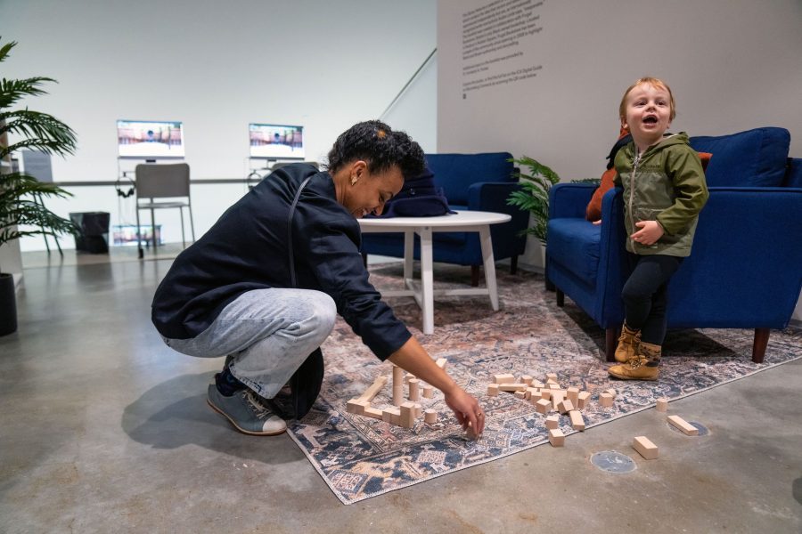Child and adult playing with wooden blocks in ICA mediatheque 