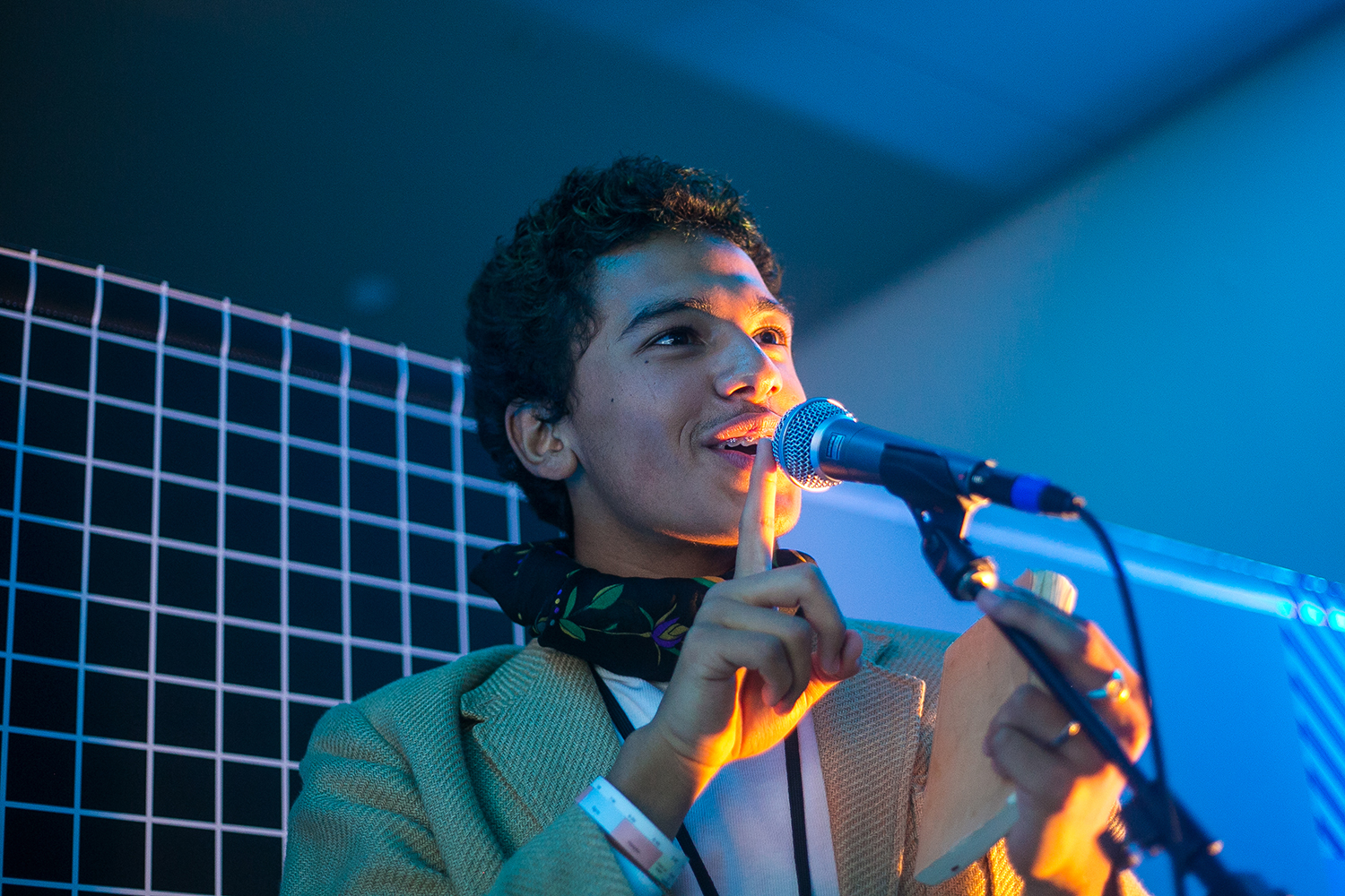 Young person speaking into microphone