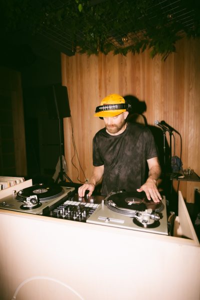 a man on stage looking down djing