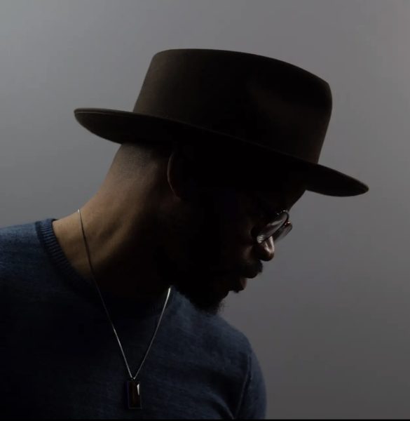 the profile of a man in a black hat