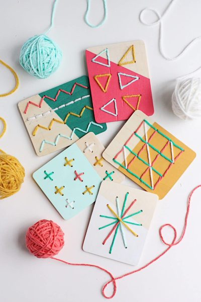 Yarn balls and embroidery craft activity with colorful cards