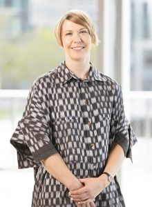 Photo of Ruth Erickson (curator) wearing a black and white dress