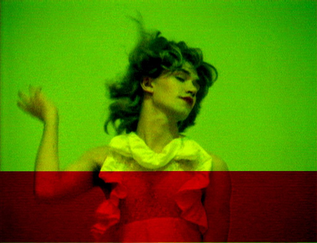 A manipulated video still showing a fair-skinned person in a white dress and red lipstick in motion.