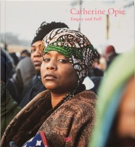 Square book cover of Catherine Opie: Empty and Full, with a crowd photo prominently featuring a Black woman with a head wrap