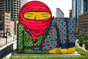 A colorful mural by artist Os Gemeos on a building in Boston. It features a large figure with a red scarf and patterned clothing, set against an urban backdrop of skyscrapers and trees. Text at the bottom includes exhibition details at the ICA Boston.