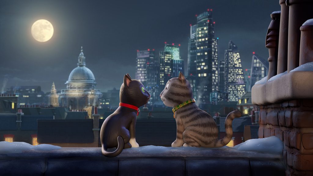 Two animated cats wearing a red collar and a green collar sit on a snowy rooftop at night, gazing at each other. A full moon and city skyline with tall buildings in the background create a romantic scene.