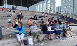 People painting outside on the ICA grandstand