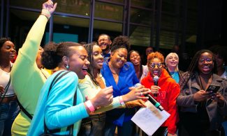 A group of people singing at a party