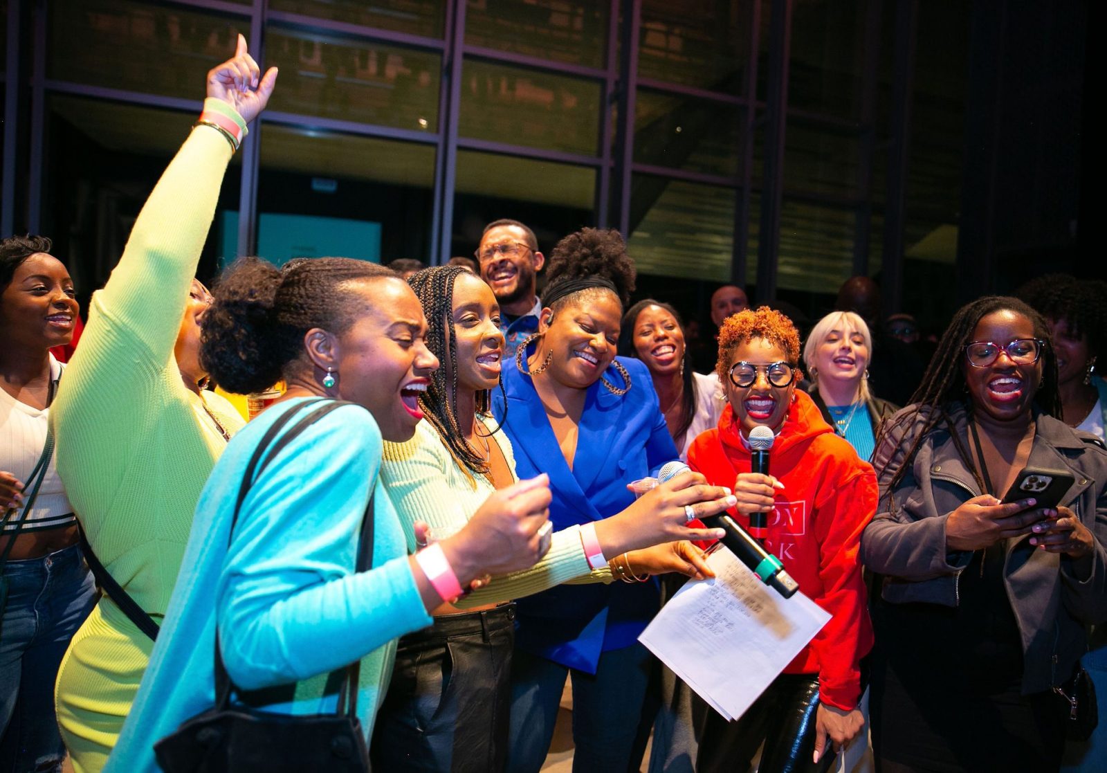 A group of people singing at a party