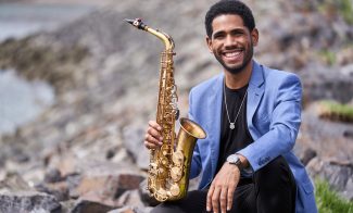 Headshot of Samuel Batista with his saxophone