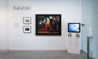An art gallery wall at ICA Boston displays three framed artworks and a video screen with headphones. The wall reads BARBARA LEE FAMILY FOUNDATION THEATER.